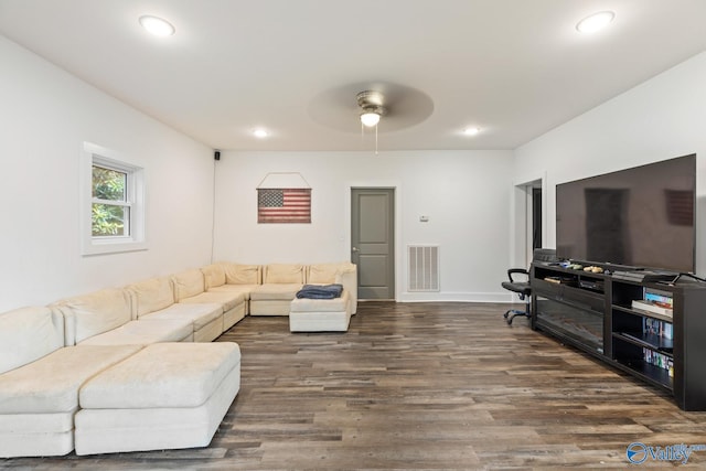 living room featuring hardwood / wood-style floors and ceiling fan