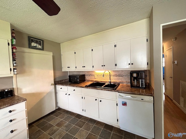 1300 7th Ave, Athens, AL 35611 - kitchen with dishwasher, a sink, dark countertops, white cabinets, and a textured ceiling