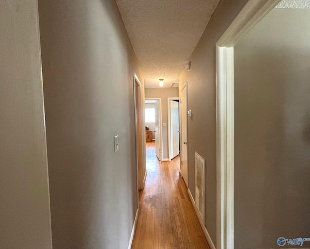 1300 7th Ave, Athens, AL 35611 - hall featuring a textured ceiling, light wood-style flooring, and baseboards