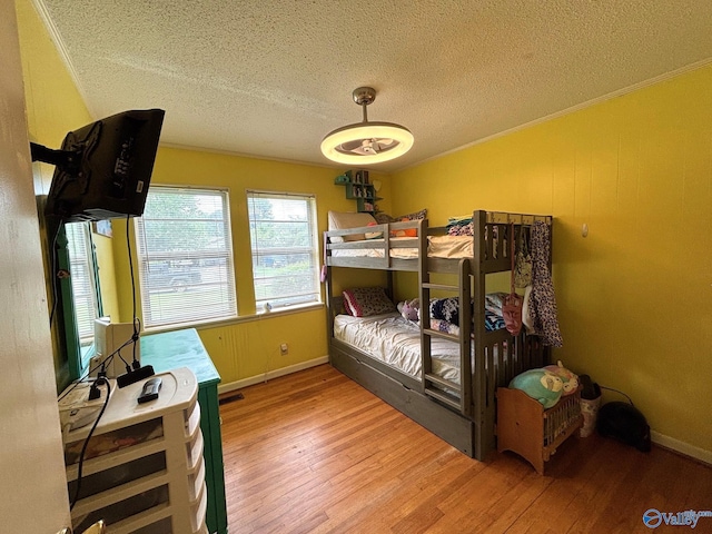 1300 7th Ave, Athens, AL 35611 - bedroom featuring light wood finished floors, a textured ceiling, ornamental molding, and baseboards