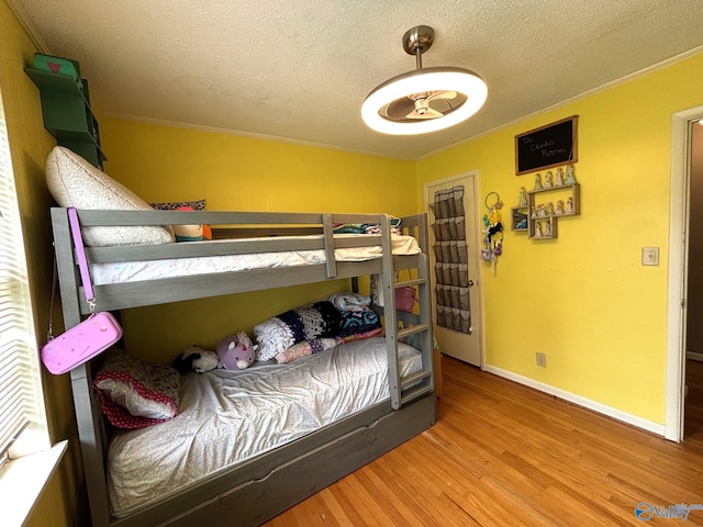 1300 7th Ave, Athens, AL 35611 - bedroom with crown molding, a textured ceiling, wood finished floors, and baseboards