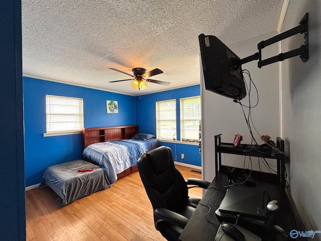 1300 7th Ave, Athens, AL 35611 - bedroom with a desk, a textured ceiling, multiple windows, hardwood / wood-style flooring, and ceiling fan