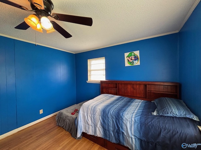 1300 7th Ave, Athens, AL 35611 - bedroom featuring wood finished floors, a textured ceiling, ornamental molding, and ceiling fan