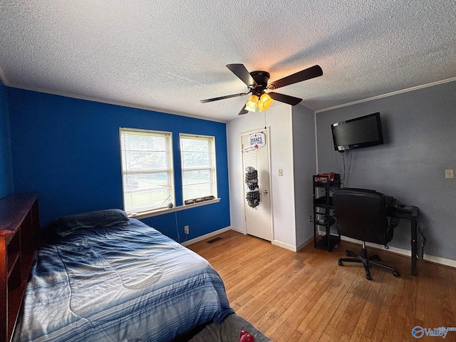 1300 7th Ave, Athens, AL 35611 - bedroom with wood-type flooring, a textured ceiling, ceiling fan, and baseboards