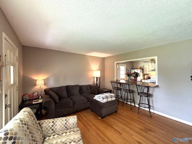 1300 7th Ave, Athens, AL 35611 - living area featuring wood finished floors, a textured ceiling, and baseboards