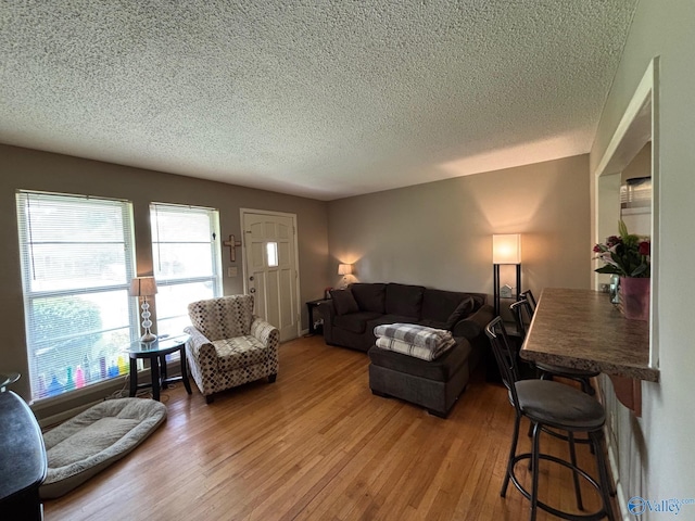 1300 7th Ave, Athens, AL 35611 - living room featuring a textured ceiling and light wood-type flooring