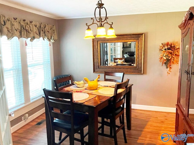 dining space featuring a notable chandelier and light hardwood / wood-style flooring