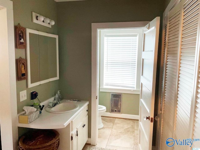 bathroom featuring tile patterned floors, toilet, and vanity