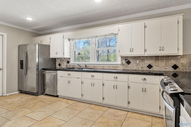 kitchen featuring a sink, appliances with stainless steel finishes, crown molding, and white cabinetry