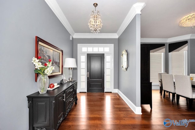 entryway with a chandelier, dark wood-style flooring, crown molding, and baseboards