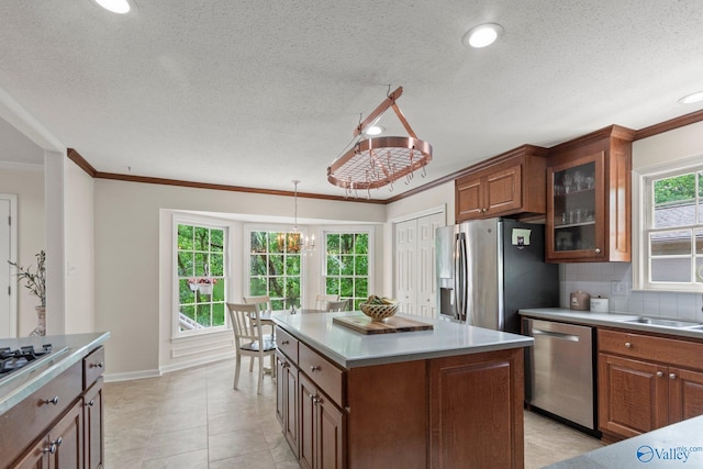 kitchen featuring brown cabinets, stainless steel appliances, and light countertops