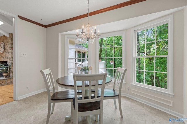 dining space with light tile patterned floors, a chandelier, a healthy amount of sunlight, and baseboards