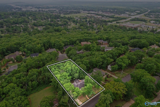 birds eye view of property with a view of trees