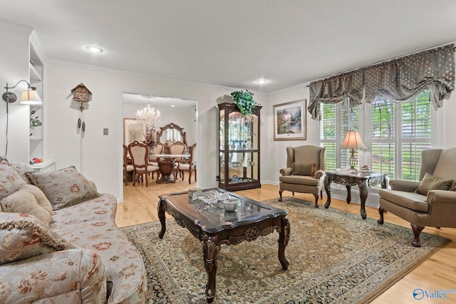 living room featuring crown molding, recessed lighting, wood finished floors, and a chandelier