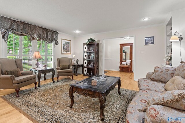 living area featuring wood finished floors, recessed lighting, ornamental molding, and baseboards