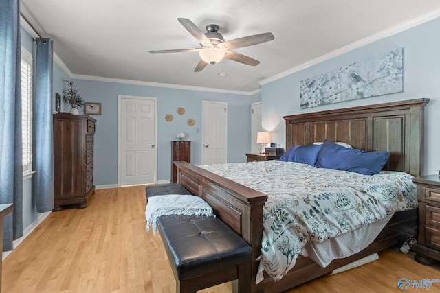 bedroom with light wood-type flooring, crown molding, a ceiling fan, and baseboards