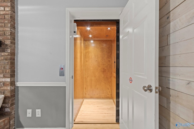 interior space featuring wood finished floors and elevator