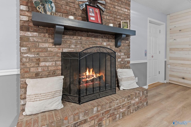 interior details featuring baseboards, wood finished floors, and a fireplace
