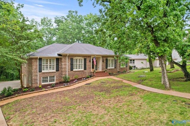 ranch-style house with brick siding and a front yard