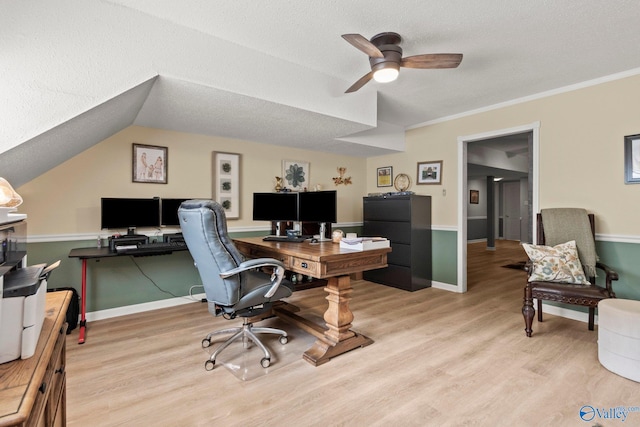 home office with a ceiling fan, baseboards, wood finished floors, and a textured ceiling