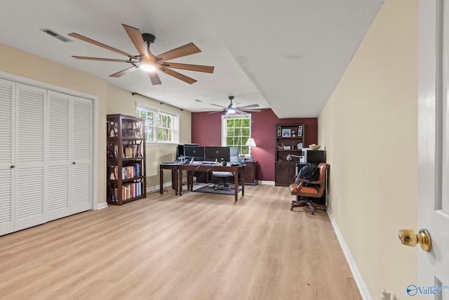 office with baseboards, visible vents, wood finished floors, and ceiling fan
