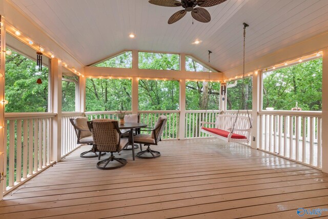 wooden terrace featuring outdoor dining space and ceiling fan