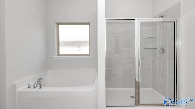 bathroom with shower with separate bathtub