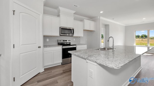 kitchen featuring a kitchen island with sink, stainless steel appliances, and white cabinets