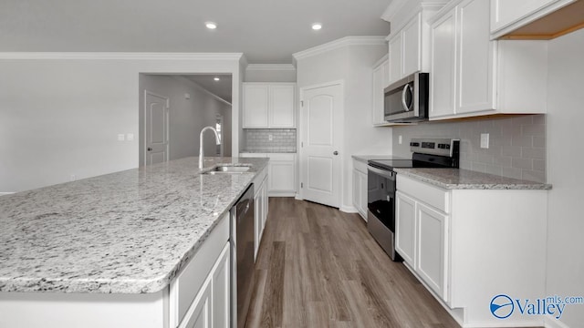 kitchen with white cabinetry, an island with sink, stainless steel appliances, and sink