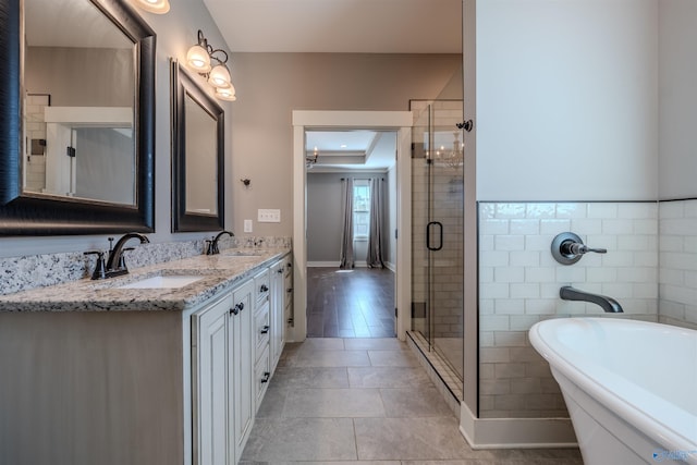 bathroom with vanity, tile patterned flooring, and plus walk in shower