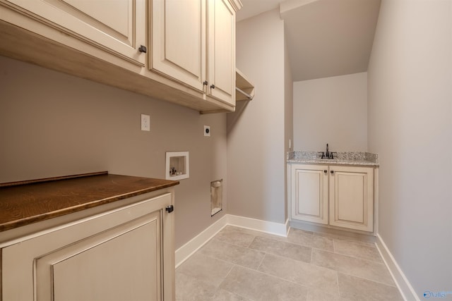 laundry room featuring hookup for a washing machine, hookup for an electric dryer, sink, cabinets, and light tile patterned floors