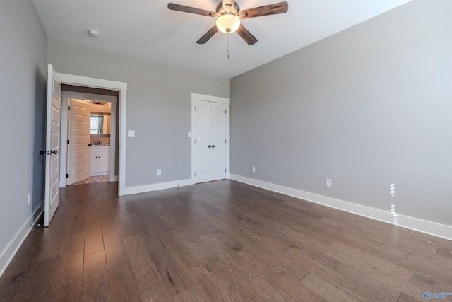 unfurnished bedroom with a closet, dark hardwood / wood-style floors, and ceiling fan