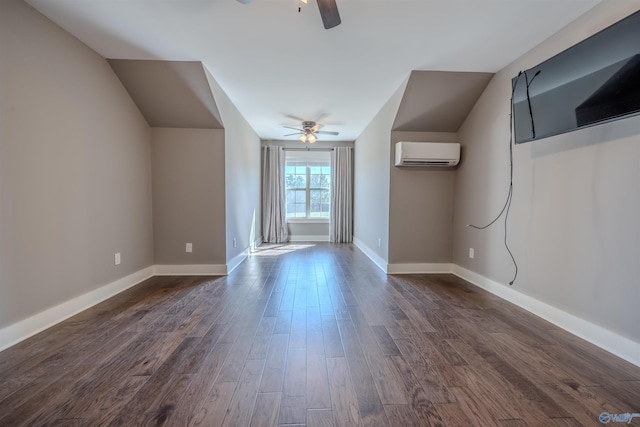 additional living space featuring a wall mounted air conditioner, lofted ceiling, dark wood-type flooring, and ceiling fan