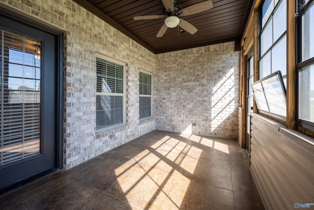 unfurnished sunroom with wood ceiling and ceiling fan