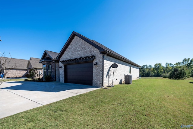 view of property exterior with central air condition unit, a garage, and a lawn