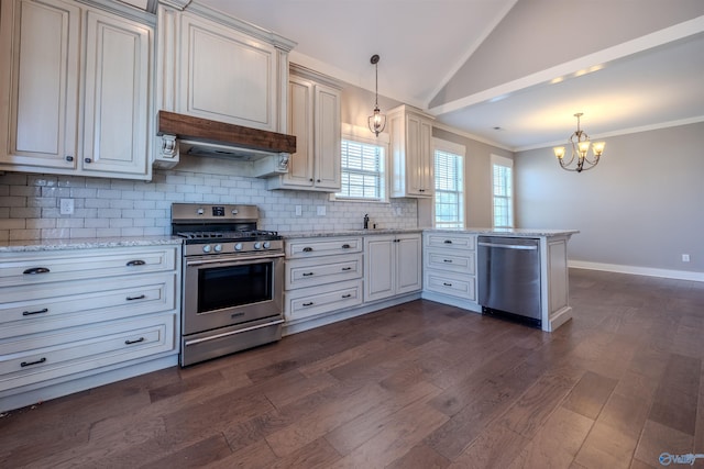 kitchen with appliances with stainless steel finishes, kitchen peninsula, decorative light fixtures, and dark wood-type flooring