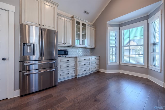 kitchen with stainless steel appliances, lofted ceiling, plenty of natural light, and dark hardwood / wood-style floors