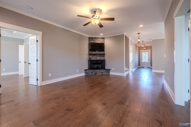 unfurnished living room featuring a fireplace, ornamental molding, and dark hardwood / wood-style floors