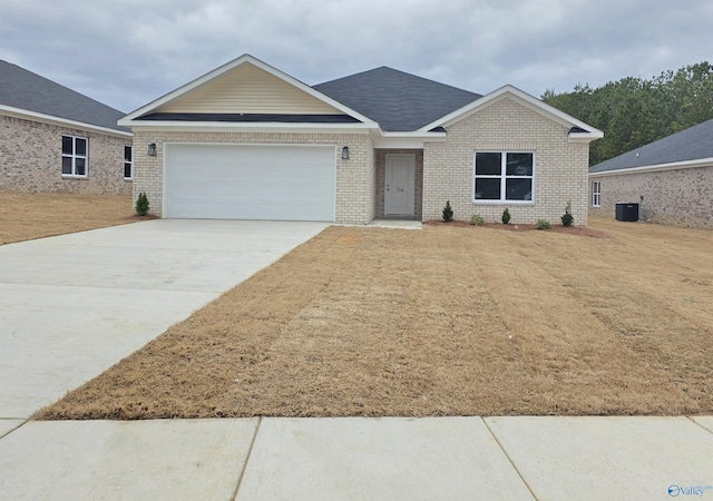 ranch-style house featuring central air condition unit, brick siding, a garage, and driveway