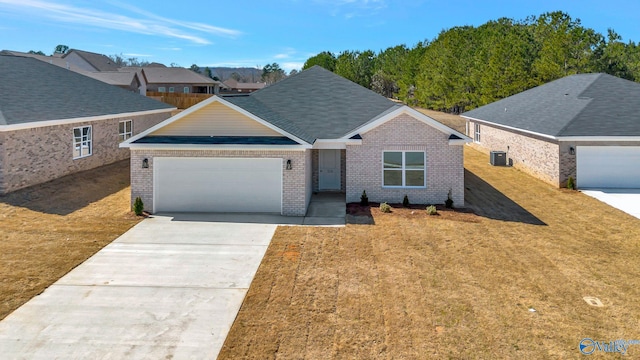 ranch-style house featuring a front yard, cooling unit, concrete driveway, a garage, and brick siding