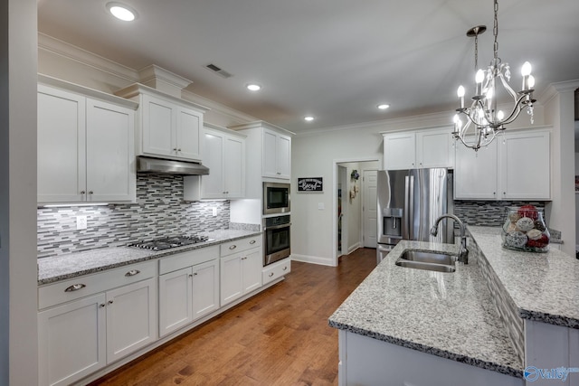 kitchen featuring sink, white cabinetry, tasteful backsplash, decorative light fixtures, and stainless steel appliances