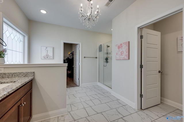 bathroom with vanity, a chandelier, and walk in shower