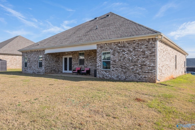 back of house with a lawn and a patio