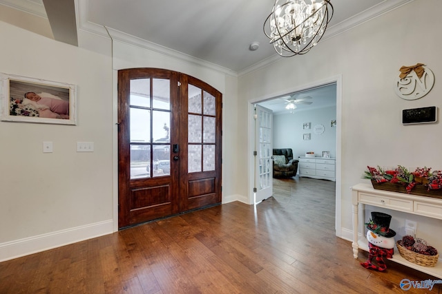 entryway featuring an inviting chandelier, dark hardwood / wood-style floors, ornamental molding, and french doors