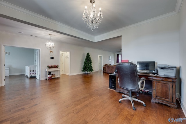 office space with a notable chandelier, hardwood / wood-style flooring, and ornamental molding