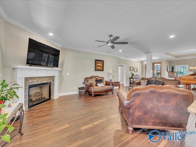 414 Wood Sage Ln, Huntsville, AL 35824 - living area featuring wood finished floors, ornamental molding, a fireplace, and a ceiling fan
