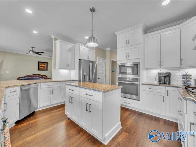414 Wood Sage Ln, Huntsville, AL 35824 - kitchen with ornamental molding, white cabinets, dark wood finished floors, appliances with stainless steel finishes, and ceiling fan