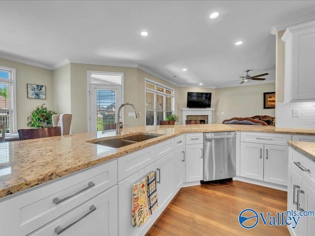 414 Wood Sage Ln, Huntsville, AL 35824 - kitchen featuring crown molding, dishwasher, a sink, and a fireplace