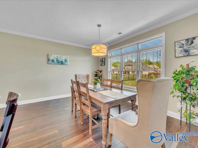 414 Wood Sage Ln, Huntsville, AL 35824 - dining area with crown molding, wood finished floors, baseboards, and visible vents