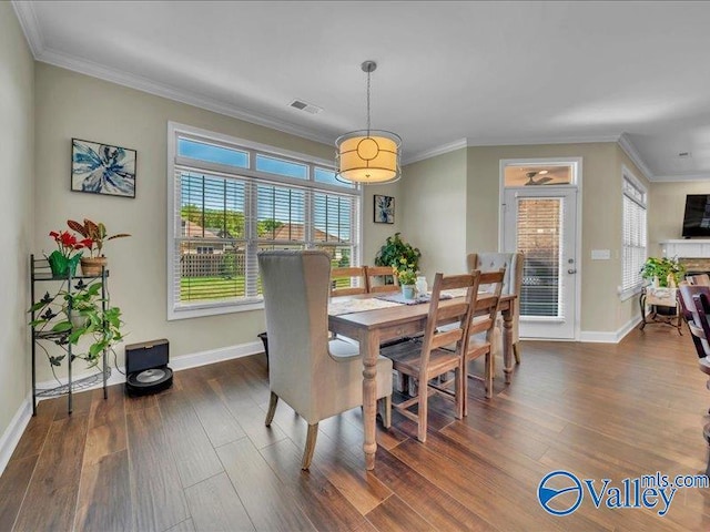 414 Wood Sage Ln, Huntsville, AL 35824 - dining area featuring crown molding, baseboards, dark wood-style floors, and visible vents